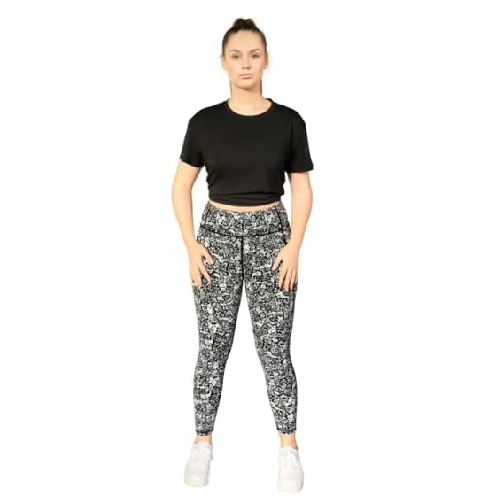 Black open back tee from Milbel Active - front view of girl modelling knotted black tee top and floral leggings