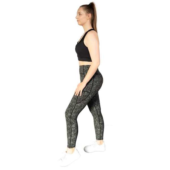 Floral black and olive full length leggings from Milbel Active - side view of girl modelling black sports bra and  floral black and olive leggings