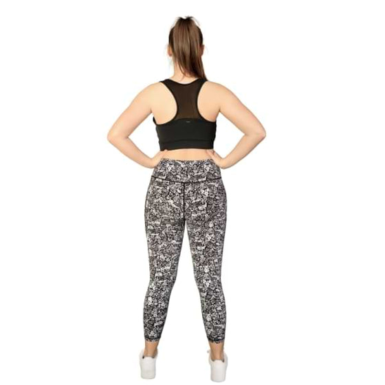 Floral black and white 7/8th leggings from Milbel Active - back view of girl modelling black sports bra and floral black and white leggings