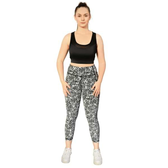 Floral black and white 7/8th leggings from Milbel Active - front view of girl modelling black sports bra and floral black and white leggings