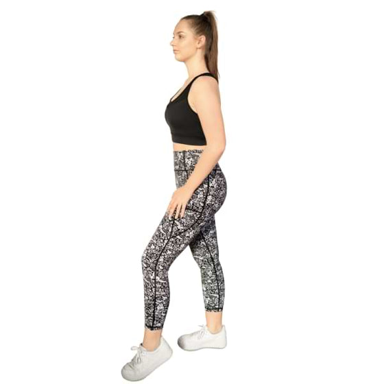 Floral black and white 7/8th leggings from Milbel Active - side view of girl modelling black sports bra and floral black and white leggings