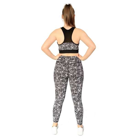 Floral black and white sports bra from Milbel Active - back view of girl modelling floral black and white sports bra and leggings